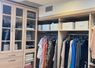 Walk-in closet entrance with warm lighting