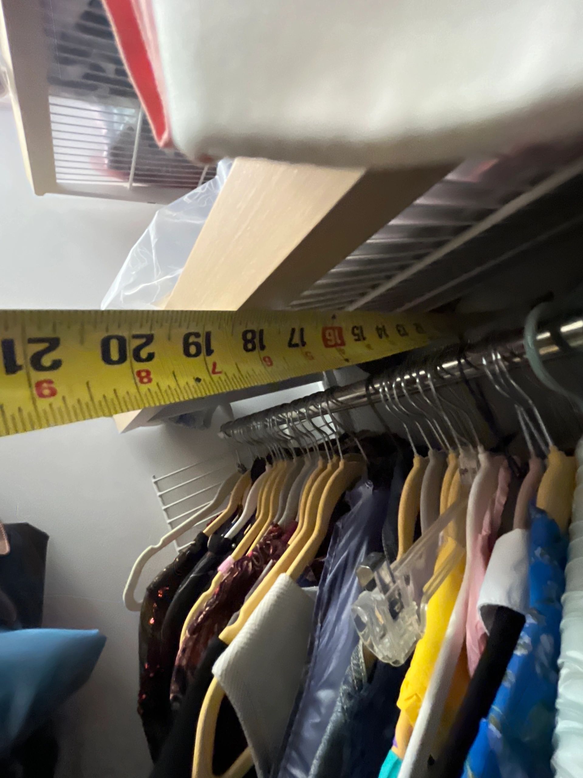 Clothing rack with colorful garments and measuring tape